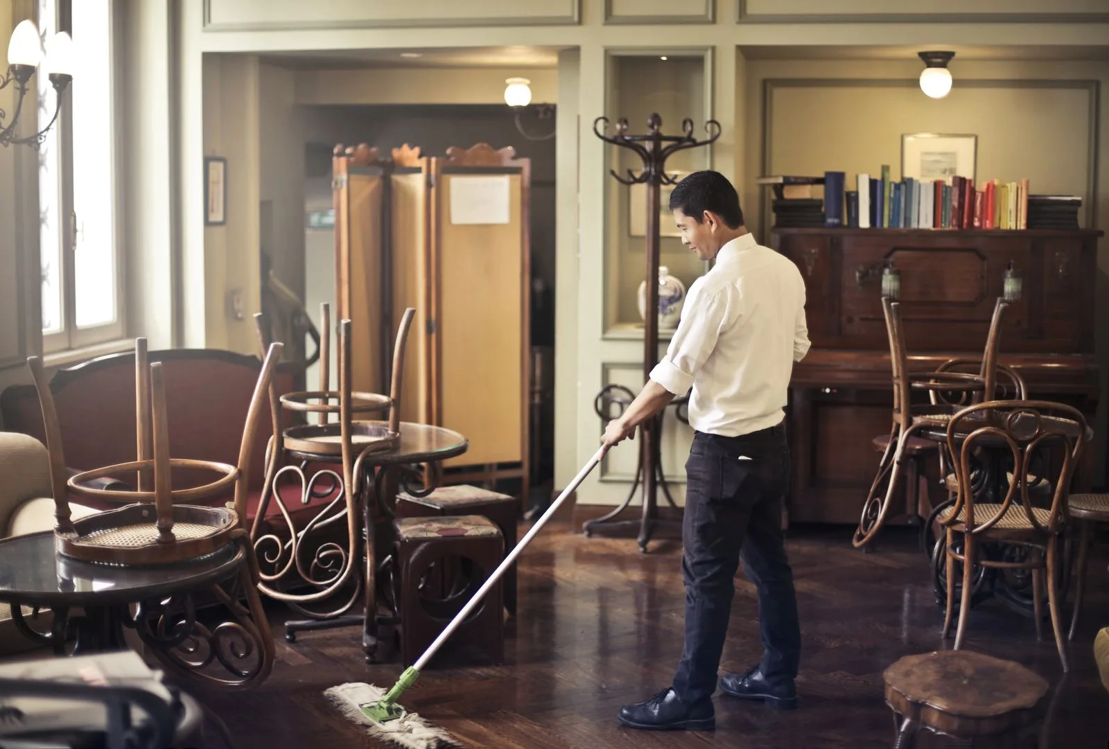 A professional mopping a commercial floor to a complete reset after hours.