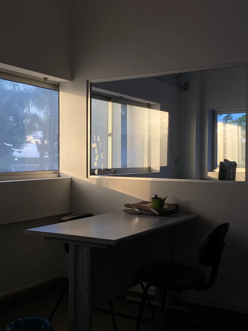 A quiet office desk in the low light of early evening.