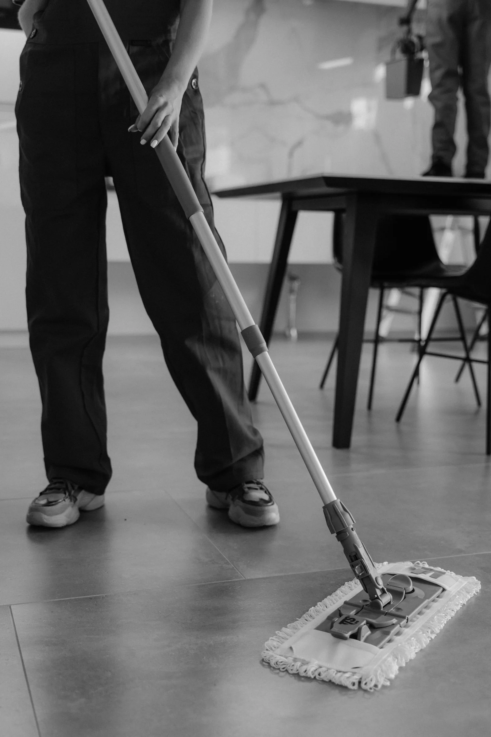 An Ecco crew member mopping a polished commercial floor to a complete reset.