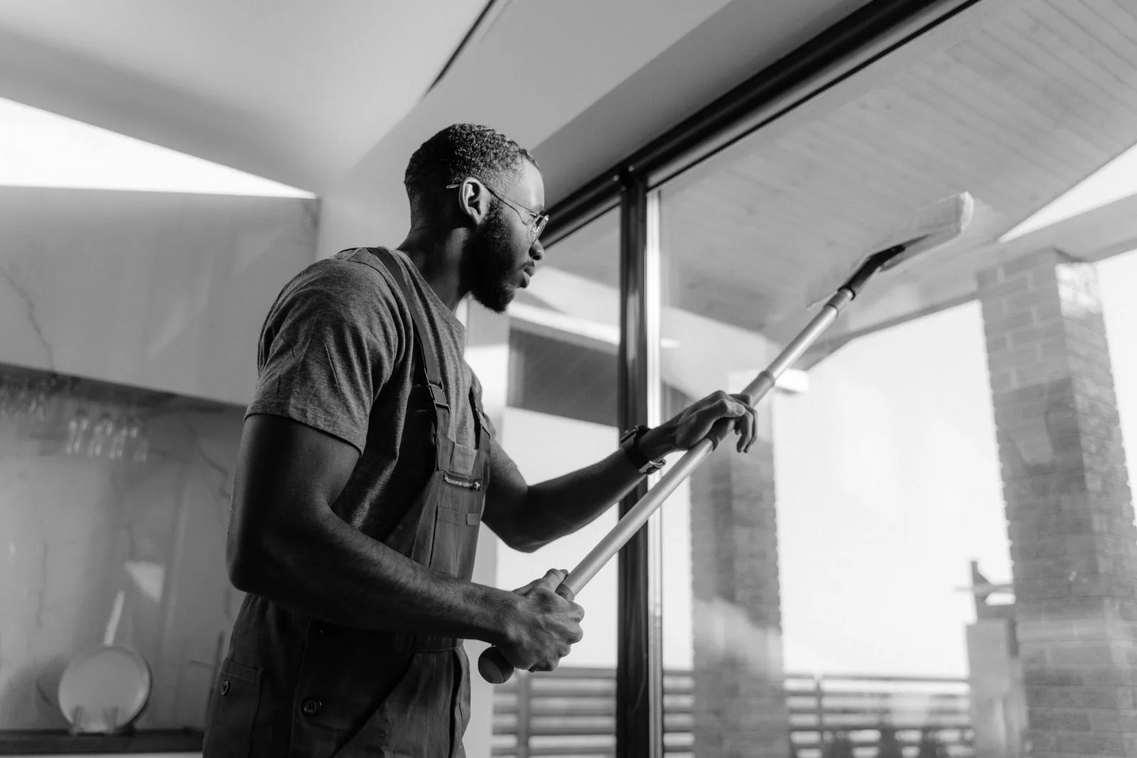 An Ecco professional cleaning interior glass in a modern space.