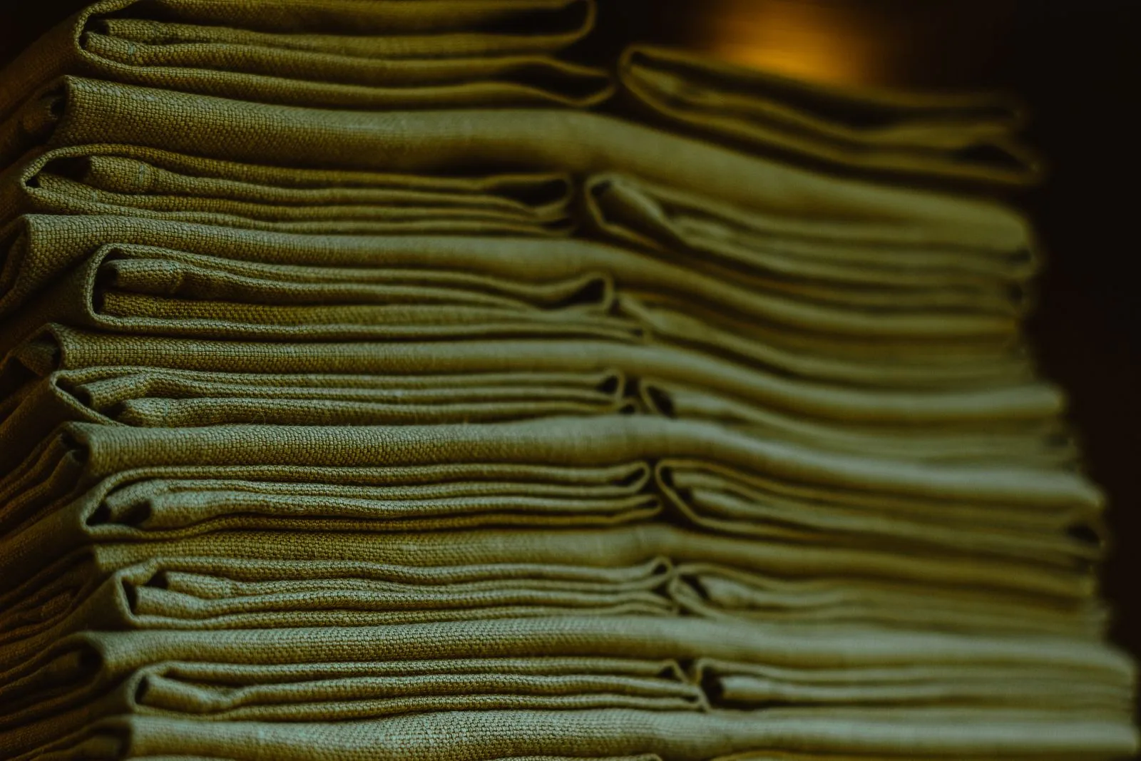 A neat stack of folded green cloths.