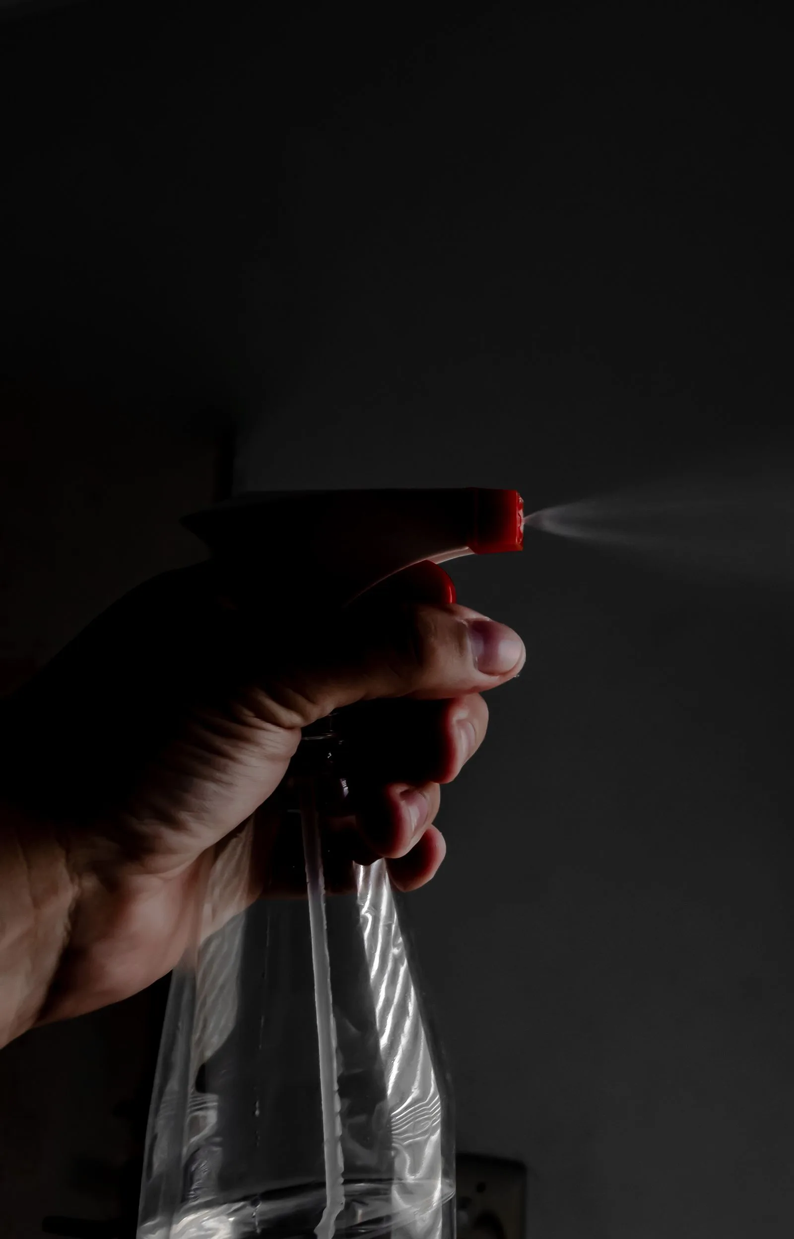 A cleaning product being applied with precision in low light.